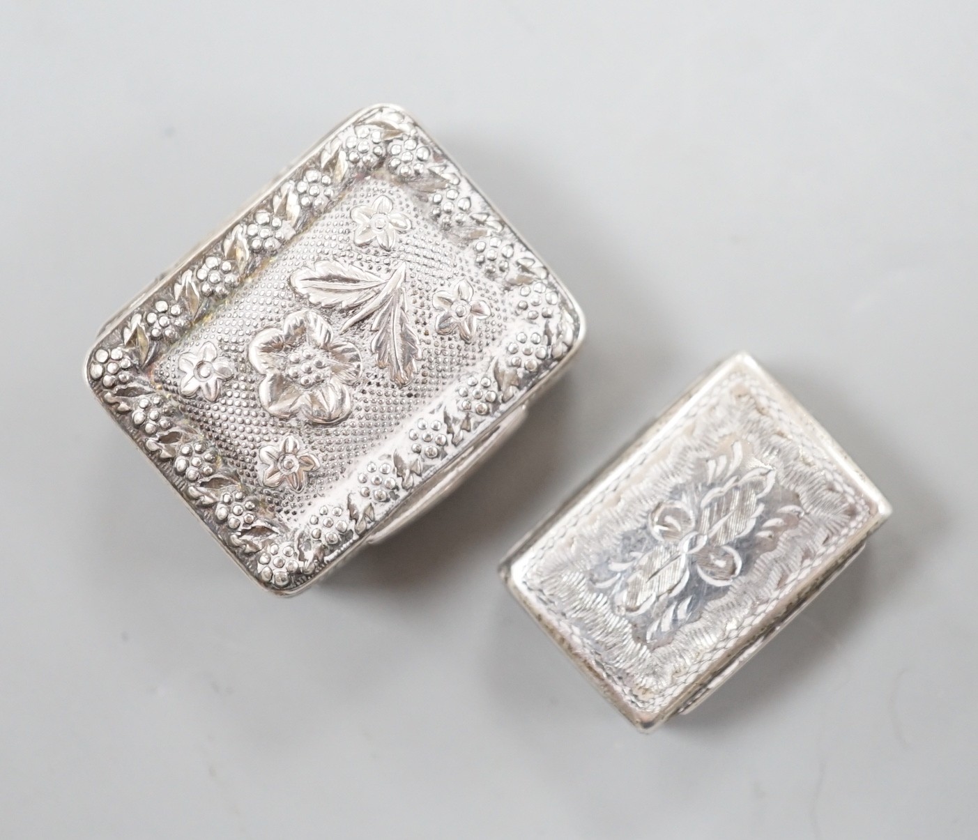 A George IV silver vinaigrette, embossed with flowers and flower heads, Ledsam & Vale?, Birmingham, 1820, 25mm and one other smaller Victorian silver vinaigrette, by Edward Smith.